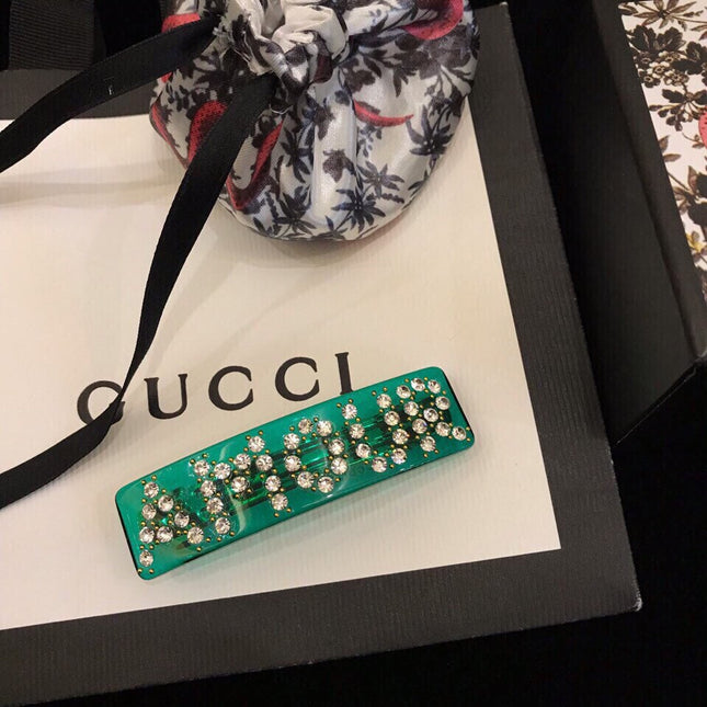 GUCCI 26S CRYSTAL LOGO HAIR CLIP IN GREEN RESIN AND GOLD TONE METAL