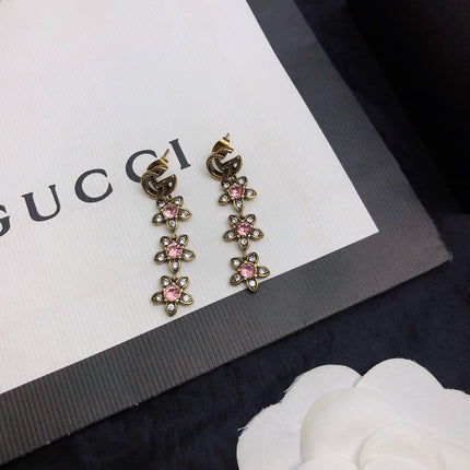 GUCCI 26S DOUBLE G LOGO PINK CRYSTAL FLORAL DROP EARRINGS IN AGED GOLD TONE METAL 629030