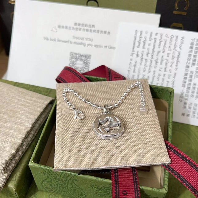 GUCCI 26S INTERLOCKING G LOGO CRYSTAL DISC PENDANT NECKLACE IN SILVER TONE METAL