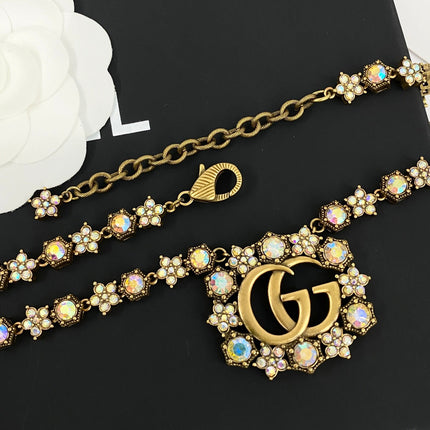 GUCCI 26S INTERLOCKING GG CRYSTAL FLORAL LINK NECKLACE IN ANTIQUE GOLD TONE METAL 620394