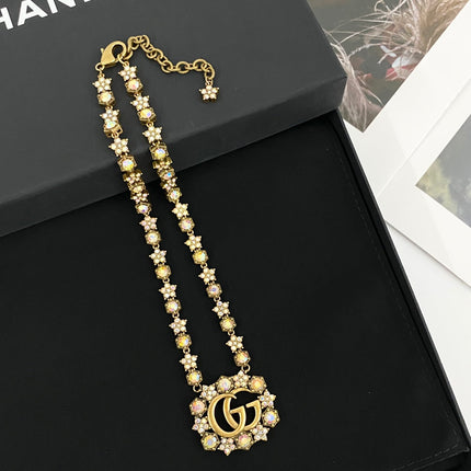 GUCCI 26S INTERLOCKING GG CRYSTAL FLORAL LINK NECKLACE IN ANTIQUE GOLD TONE METAL 620394