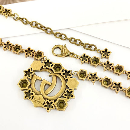 GUCCI 26S INTERLOCKING GG CRYSTAL FLORAL LINK NECKLACE IN ANTIQUE GOLD TONE METAL 620394