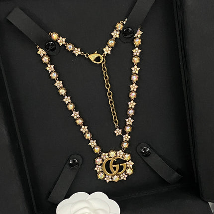 GUCCI 26S INTERLOCKING GG CRYSTAL FLORAL LINK NECKLACE IN ANTIQUE GOLD TONE METAL 620394
