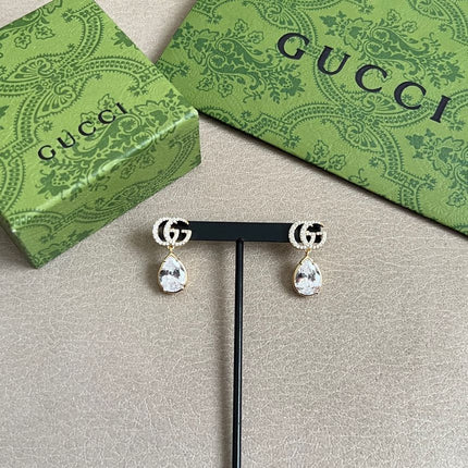 GUCCI 26S INTERLOCKING GG MINI CRYSTAL TEARDROP EARRINGS IN GOLD TONE METAL 620512
