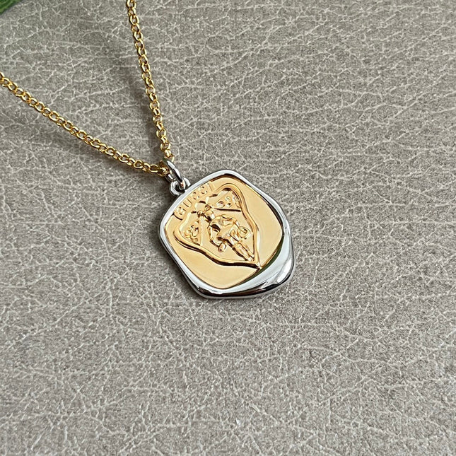 GUCCI 26S EMBLEM SHIELD PENDANT NECKLACE IN GOLD AND SILVER TONE METAL 625551