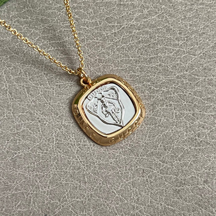 GUCCI 26S HERITAGE CREST MEDALLION PENDANT NECKLACE IN GOLD AND SILVER TONE METAL 625550