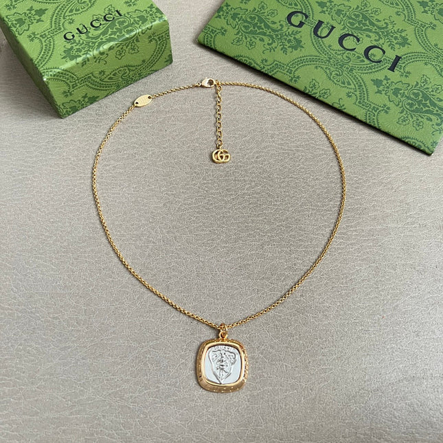 GUCCI 26S HERITAGE CREST MEDALLION PENDANT NECKLACE IN GOLD AND SILVER TONE METAL 625550