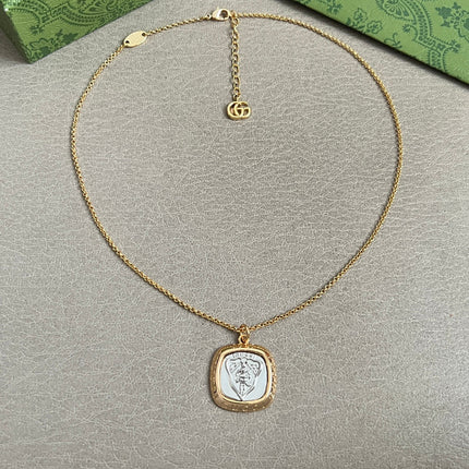 GUCCI 26S HERITAGE CREST MEDALLION PENDANT NECKLACE IN GOLD AND SILVER TONE METAL 625550