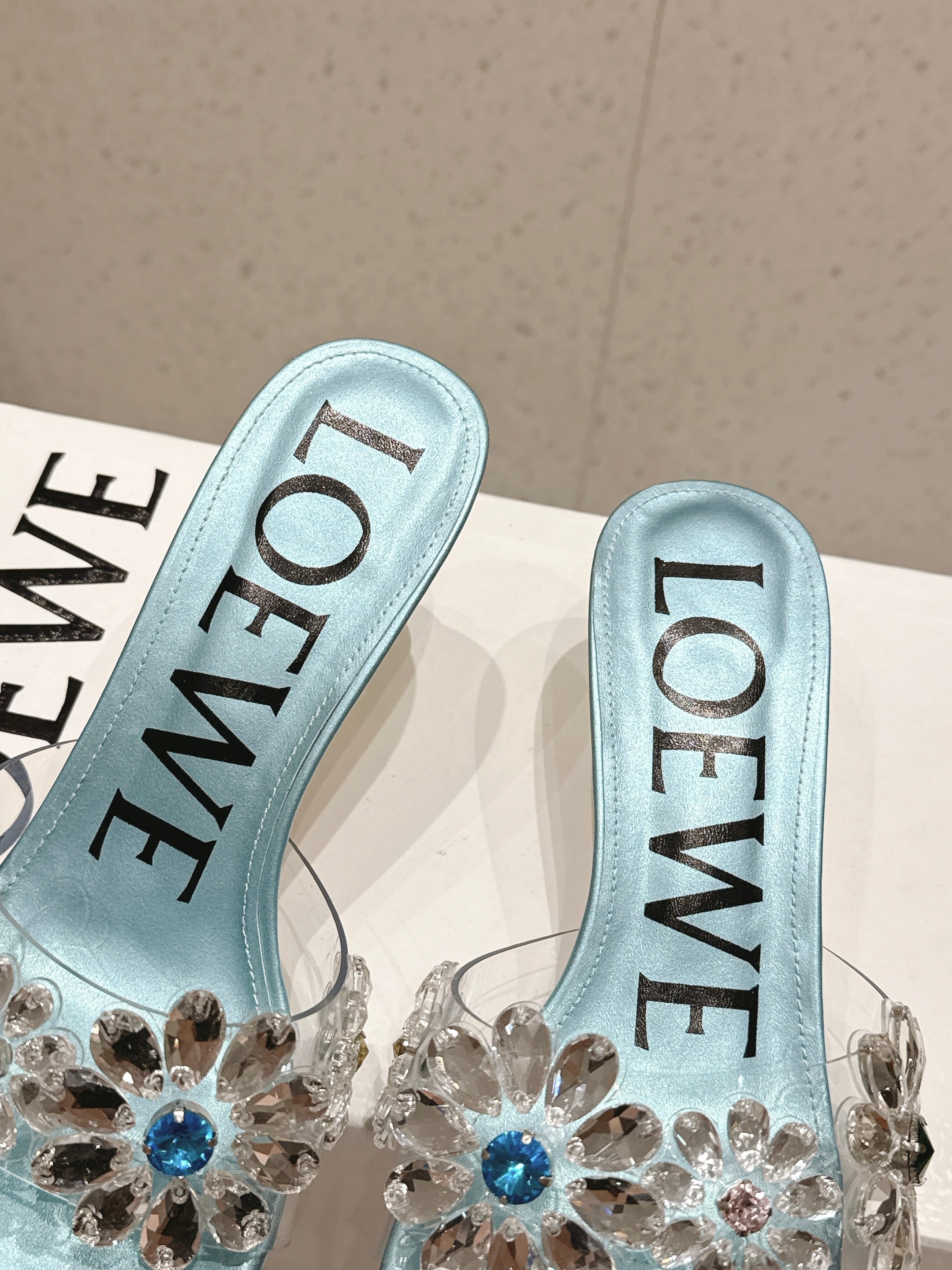 LOEWE 26S MULE HEELS 45MM IN LIGHT BLUE PVC WITH CRYSTAL FLORAL