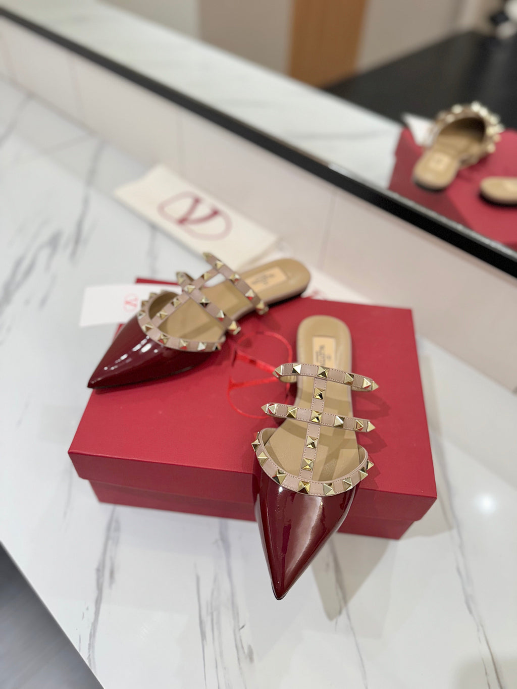 VALENTINO 26S STUDDED FLAT MULES IN DARK RED PATENT CALFSKIN
