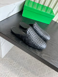 BOTTEGA VENETA 26S FLAT MULES IN BLACK WOVEN LAMBSKIN