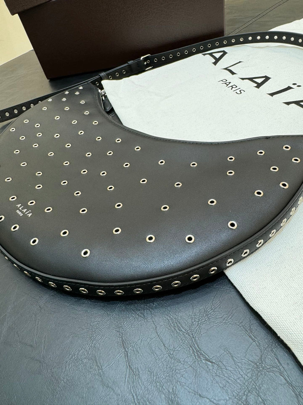 ONE PIECE DEMI LUNE BAG 31 IN BLACK SHEEPSKIN EYELET DETAILING