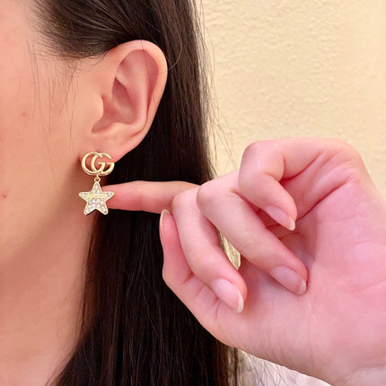 GUCCI 26S DOUBLE G STAR CRYSTAL DROP EARRINGS IN GOLD TONE METAL 627015