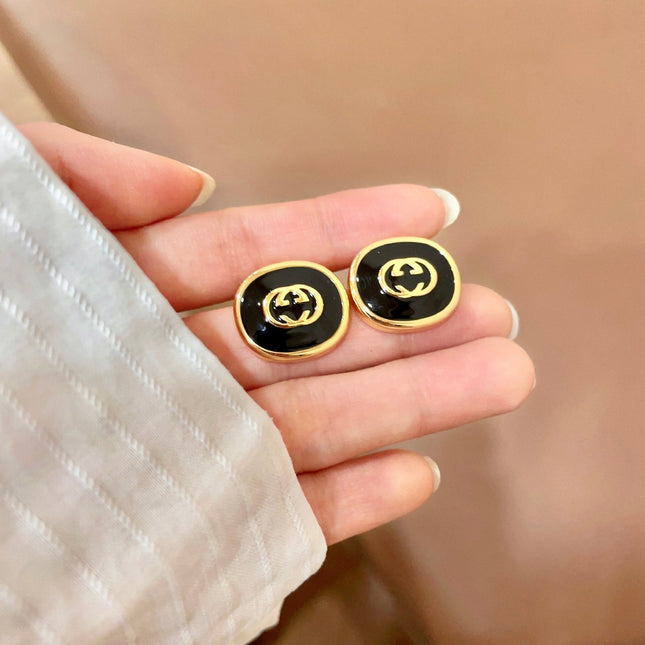 GUCCI 26S INTERLOCKING G ROUND LOGO STUD EARRINGS IN BLACK ENAMEL & GOLD TONE METAL 625716