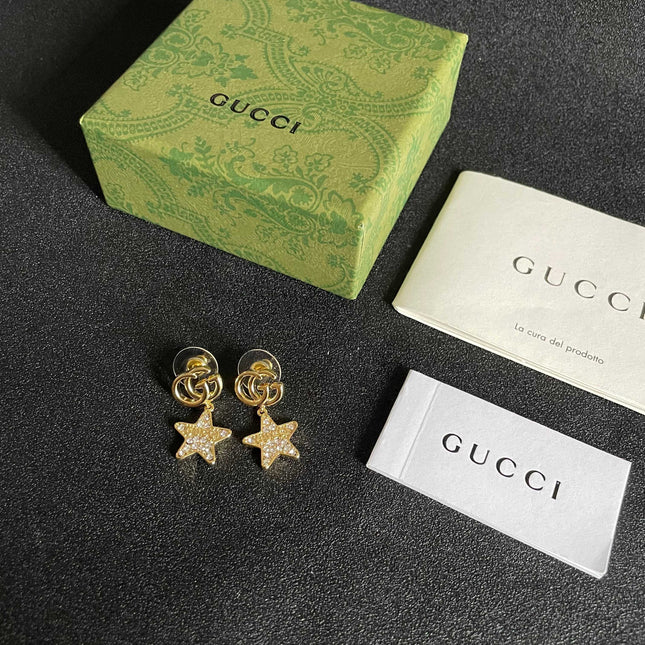 GUCCI 26S DOUBLE G STAR CRYSTAL DROP EARRINGS IN GOLD TONE METAL 627015