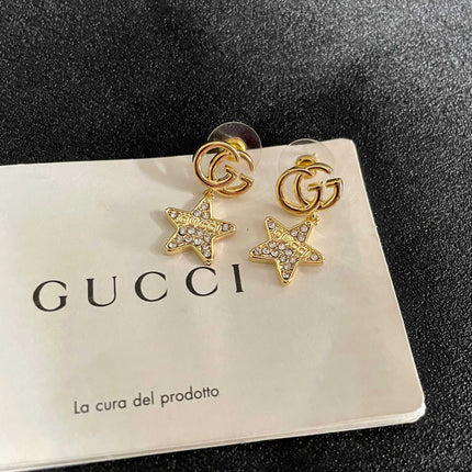 GUCCI 26S DOUBLE G STAR CRYSTAL DROP EARRINGS IN GOLD TONE METAL 627015