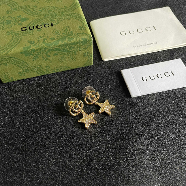 GUCCI 26S DOUBLE G STAR CRYSTAL DROP EARRINGS IN GOLD TONE METAL 627015