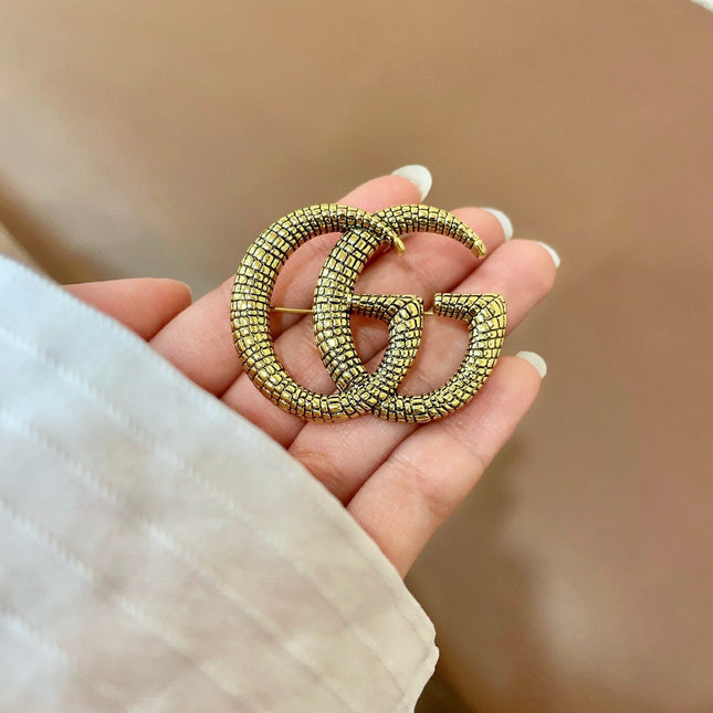 GUCCI 26S DOUBLE G LOGO TEXTURED STATEMENT BROOCH IN AGED GOLD TONE METAL 629062