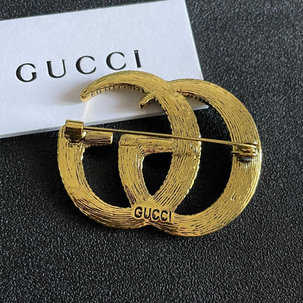 GUCCI 26S DOUBLE G LOGO TEXTURED STATEMENT BROOCH IN AGED GOLD TONE METAL 629062