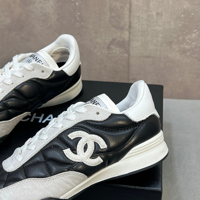 CHANEL 26S SNEAKERS IN BLACK AND WHITE QUILTED CALFSKIN CC LOGO