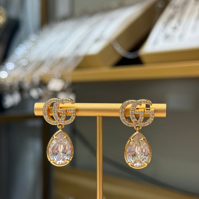 GUCCI 26S INTERLOCKING GG CRYSTAL TEARDROP EARRINGS IN GOLD TONE METAL 621443