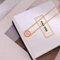 MIUMIU 26S ROUND LOGO PENDANT NECKLACE IN PINK ENAMEL AND GOLD TONE METAL 630864