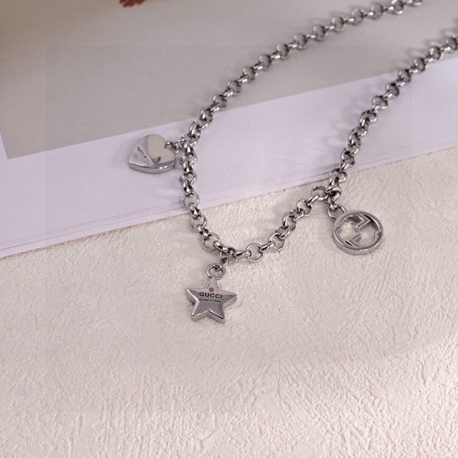 GUCCI 26S INTERLOCKING G LOGO STAR HEART MULTI CHARM CHAIN BRACELET IN SILVER TONE METAL