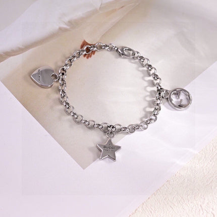 GUCCI 26S INTERLOCKING G LOGO STAR HEART MULTI CHARM CHAIN BRACELET IN SILVER TONE METAL