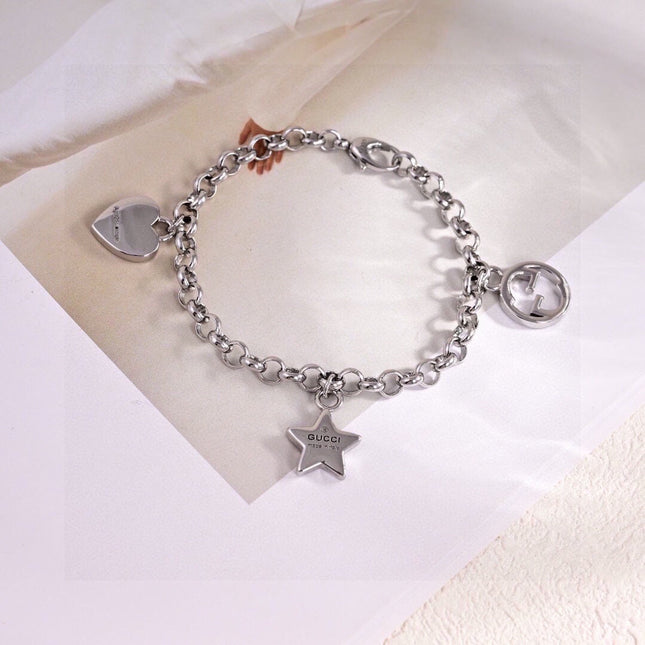 GUCCI 26S INTERLOCKING G LOGO STAR HEART MULTI CHARM CHAIN BRACELET IN SILVER TONE METAL