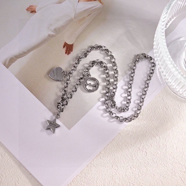 GUCCI 26S INTERLOCKING G LOGO STAR HEART MULTI CHARM CHAIN BRACELET IN SILVER TONE METAL
