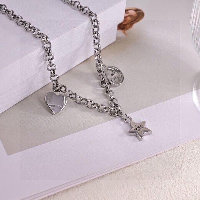 GUCCI 26S INTERLOCKING G LOGO STAR HEART MULTI CHARM CHAIN BRACELET IN SILVER TONE METAL
