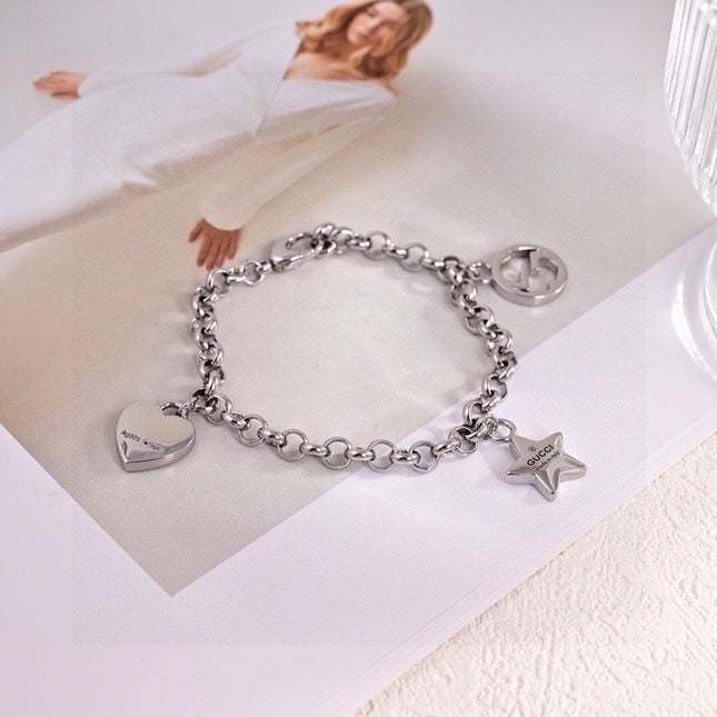 GUCCI 26S INTERLOCKING G LOGO STAR HEART MULTI CHARM CHAIN BRACELET IN SILVER TONE METAL