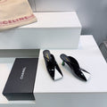 CHANEL 26S HIGH-HEEL MULES 70 MM IN BLACK AND WHITE LAMBSKIN
