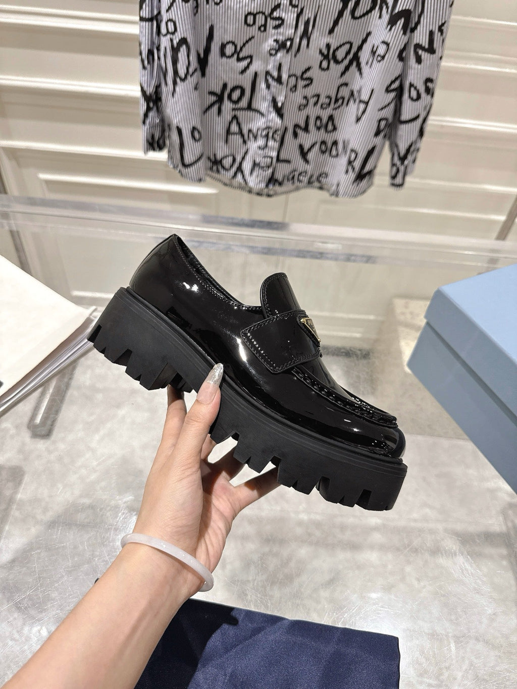 PRADA 26S PLATFORM LOAFERS 45MM IN BLACK PATENT CALFSKIN