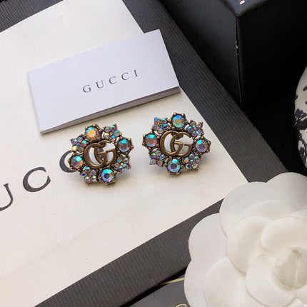 GUCCI 26S DOUBLE G LOGO MULTICOLOR CRYSTAL FLORAL STATEMENT STUD EARRINGS IN AGED GOLD TONE METAL 629028