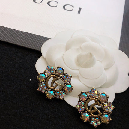 GUCCI 26S DOUBLE G LOGO MULTICOLOR CRYSTAL FLORAL STATEMENT STUD EARRINGS IN AGED GOLD TONE METAL 629028
