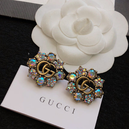 GUCCI 26S DOUBLE G LOGO MULTICOLOR CRYSTAL FLORAL STATEMENT STUD EARRINGS IN AGED GOLD TONE METAL 629028