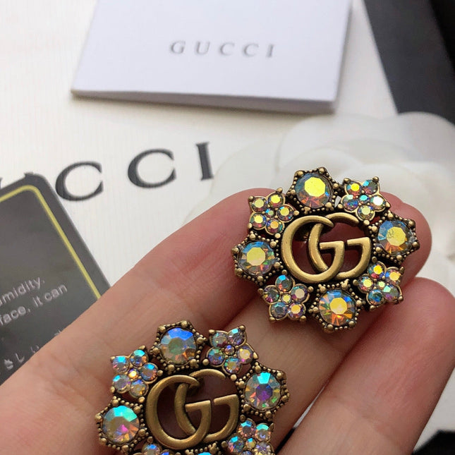 GUCCI 26S DOUBLE G LOGO MULTICOLOR CRYSTAL FLORAL STATEMENT STUD EARRINGS IN AGED GOLD TONE METAL 629028