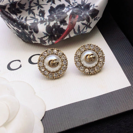 GUCCI 26S DOUBLE G LOGO PEARL CRYSTAL HALO STUD EARRINGS IN AGED GOLD TONE METAL 629031